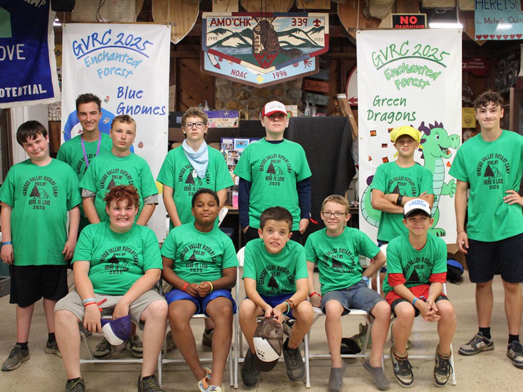Camp group photo with green shirts and banners.