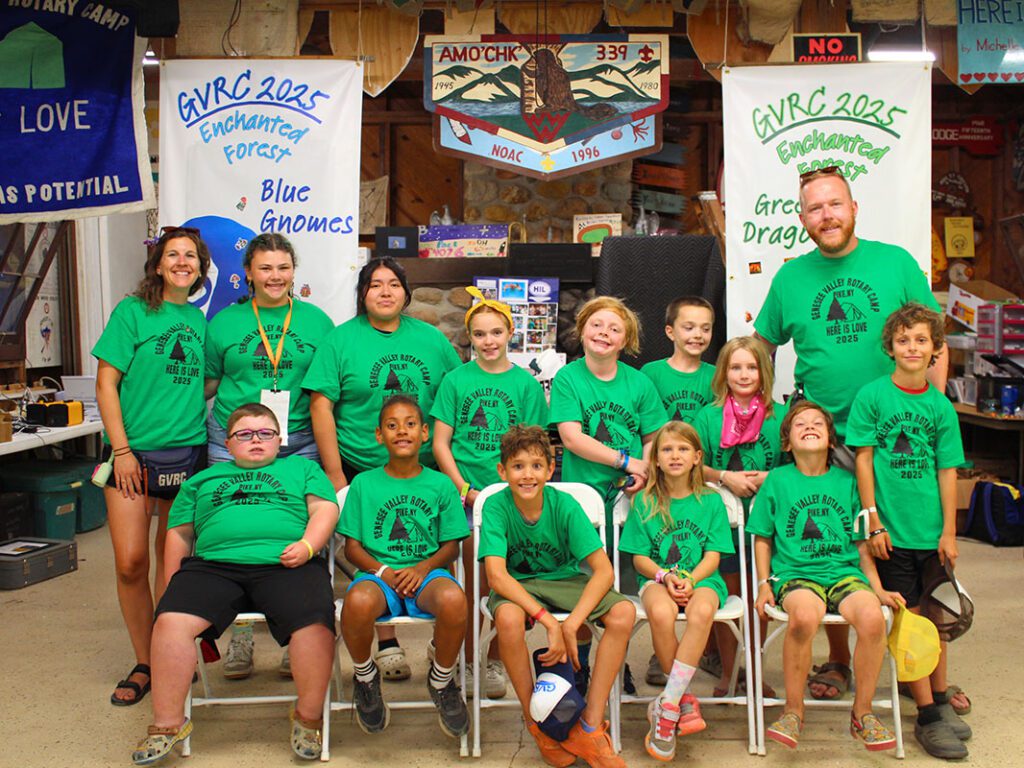 Group of smiling people at camp event.