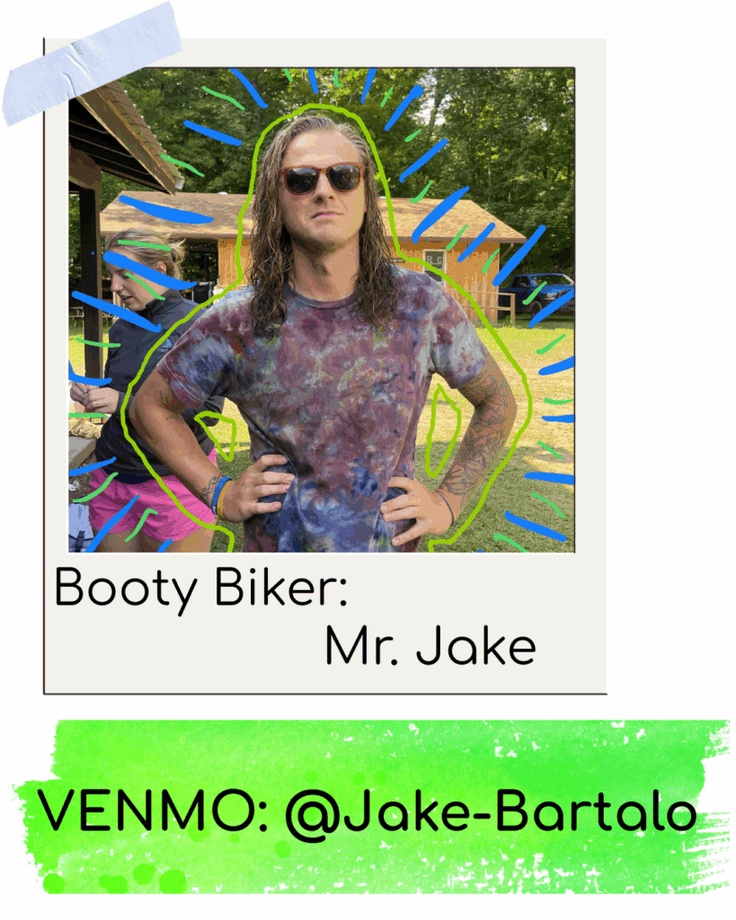 Person in sunglasses and tie-dye shirt outdoors.