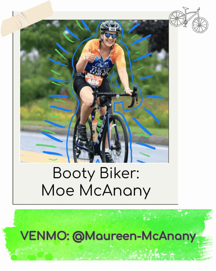 Cyclist smiling during outdoor race, wearing colorful gear.