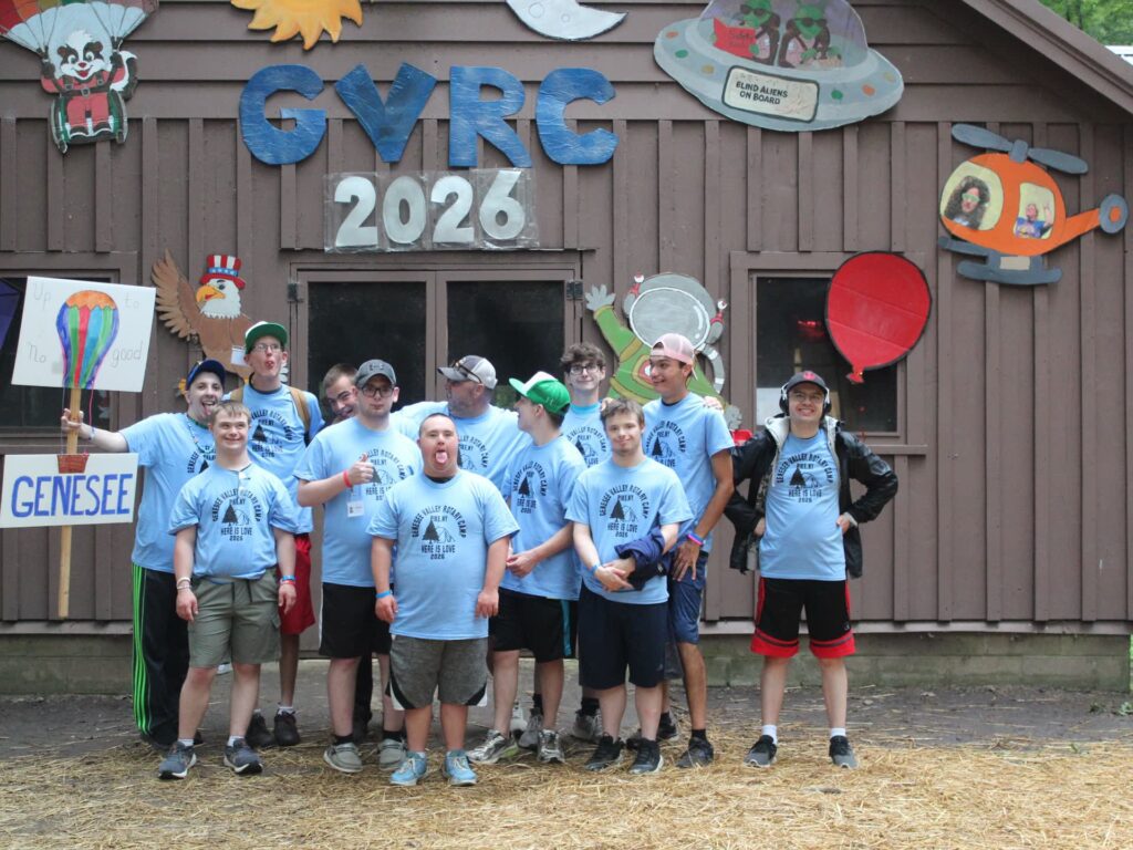Camp group wearing blue shirts poses beneath GYRC 2026 sign