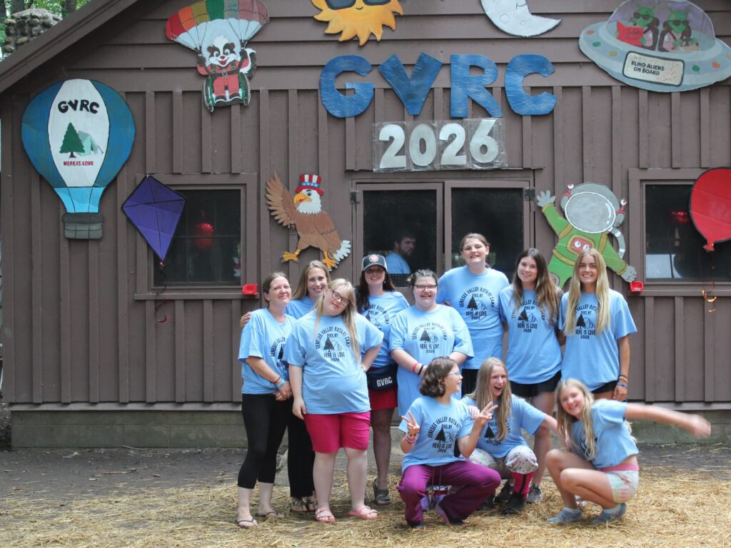 Camp group poses before decorated GVRC 2026 building