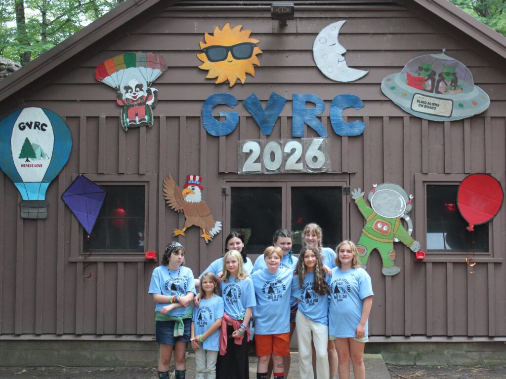 Campers pose before space-themed GVRC 2026 cabin decorations.